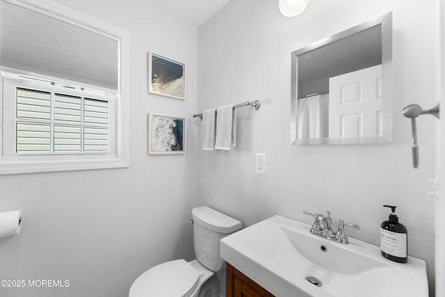 bathroom featuring toilet and vanity