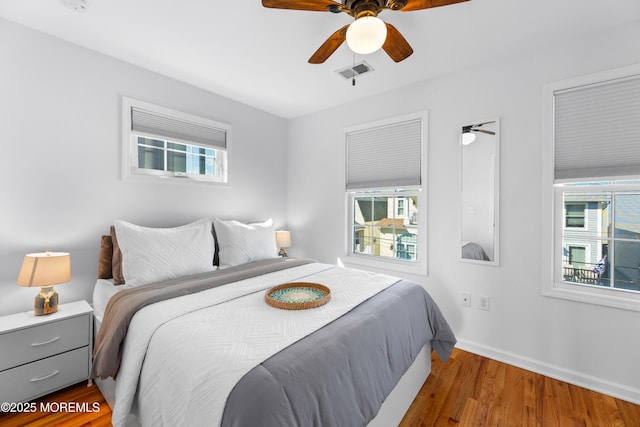 bedroom with ceiling fan and dark hardwood / wood-style floors