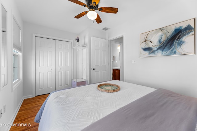 bedroom featuring ceiling fan, hardwood / wood-style floors, and a closet