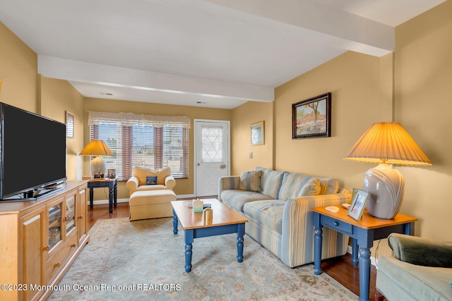 living room featuring light hardwood / wood-style floors and beam ceiling