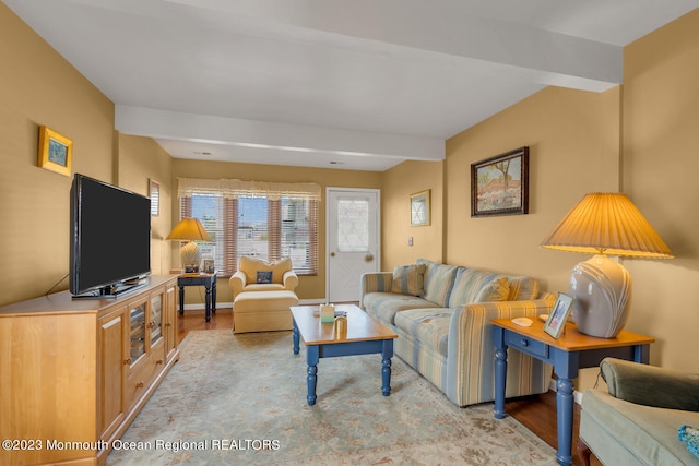 living room with beam ceiling and light hardwood / wood-style flooring