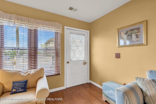 doorway featuring a wealth of natural light and hardwood / wood-style flooring