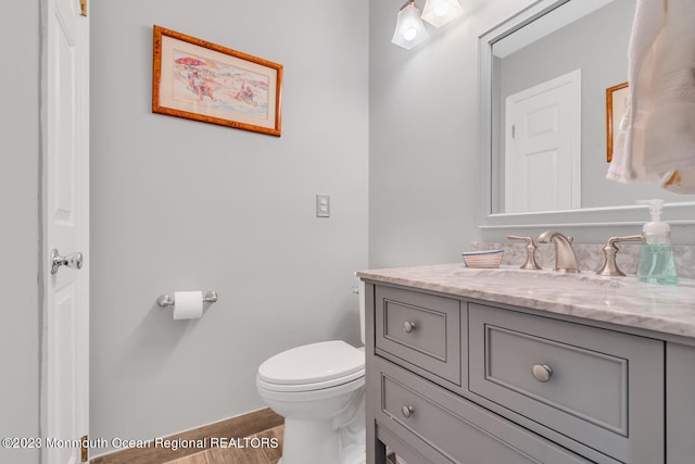 bathroom with toilet and vanity