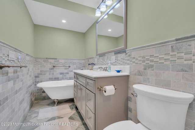 bathroom with toilet, vanity, tile walls, and a bath