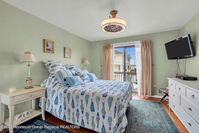 bedroom with access to exterior and dark hardwood / wood-style flooring