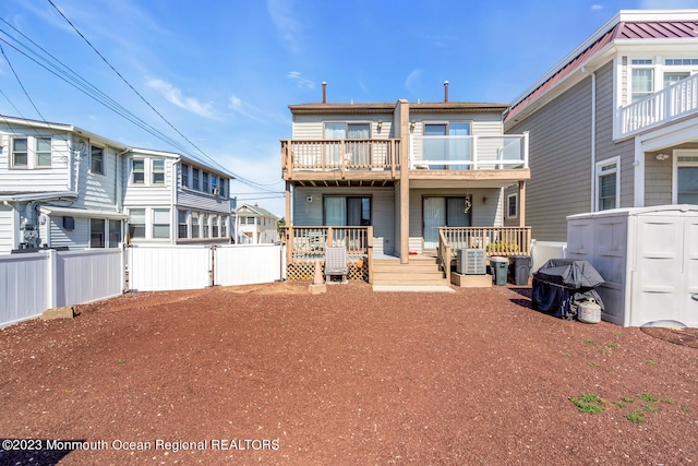 rear view of property with a balcony and central air condition unit