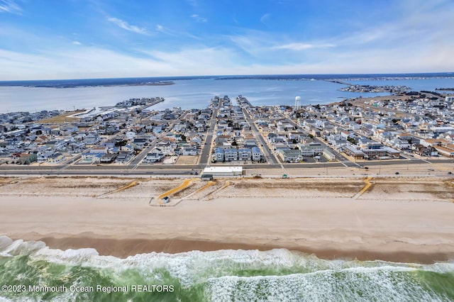 bird's eye view featuring a water view and a view of the beach