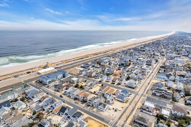 birds eye view of property with a water view and a view of the beach