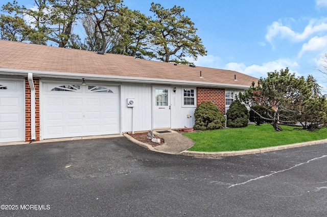 view of front of home with a garage and a front lawn