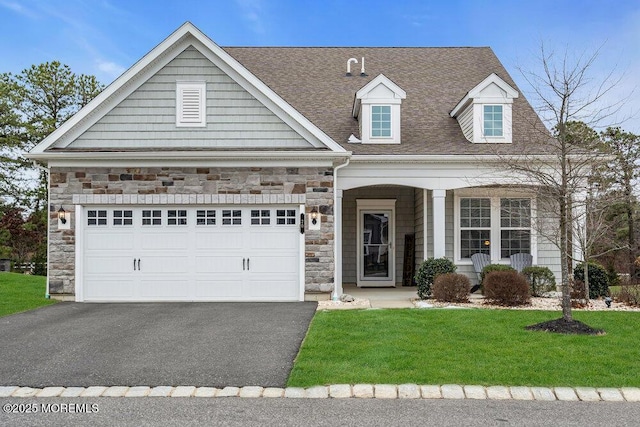 view of front of home with a front yard and a garage