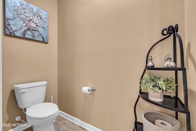 bathroom with toilet and tile patterned flooring