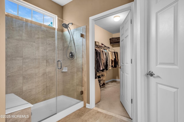 bathroom featuring a shower with door and tile patterned flooring