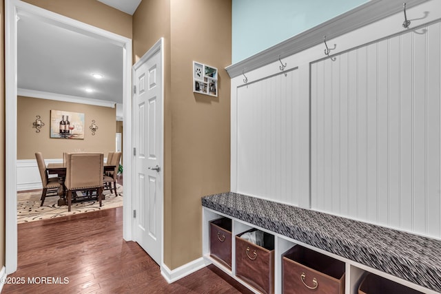 mudroom with dark wood-type flooring and ornamental molding