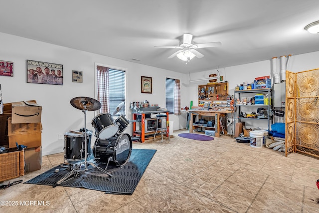 interior space featuring a workshop area and ceiling fan