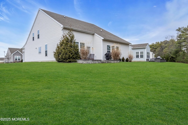 rear view of property with a yard