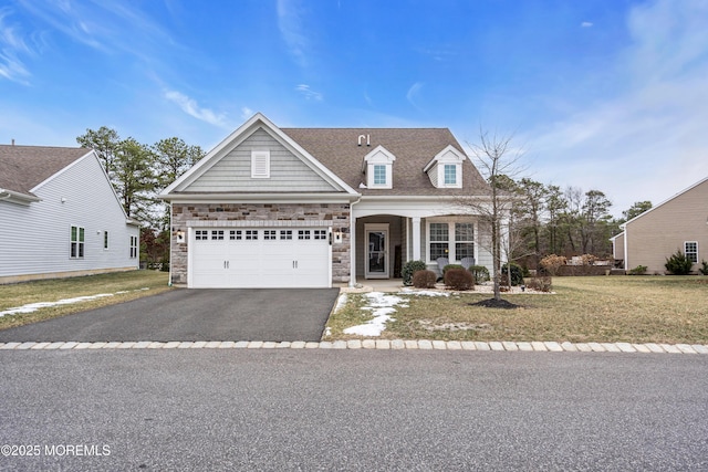 view of front of property with a front yard and a garage