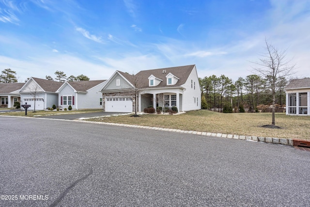 cape cod house with a front lawn and a garage