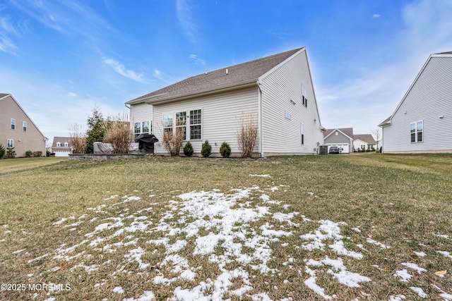 back of property featuring a lawn