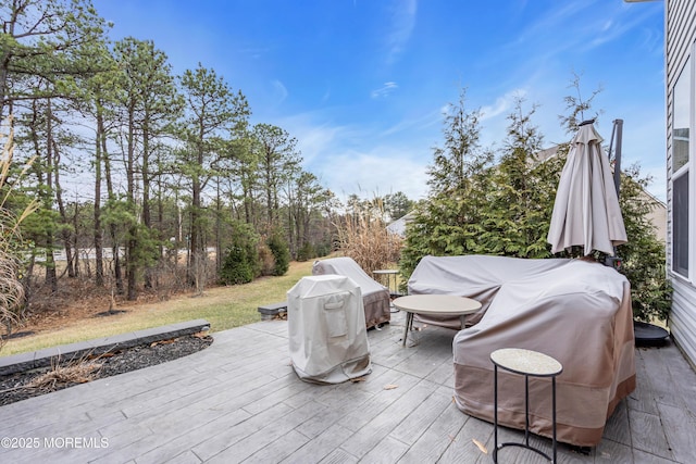 view of patio with grilling area and a wooden deck