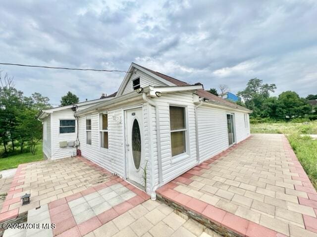 view of side of home with a patio area