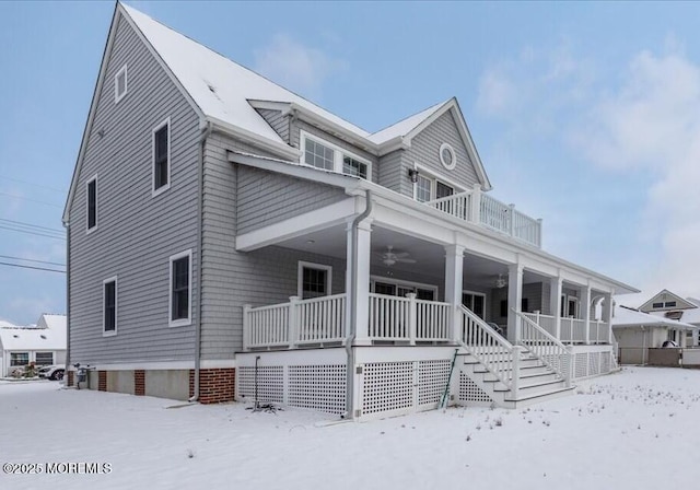 view of front of home with a porch, ceiling fan, and a balcony