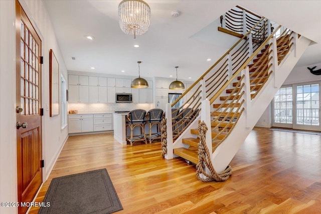 interior space with a notable chandelier and hardwood / wood-style floors