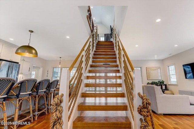 staircase with hardwood / wood-style flooring