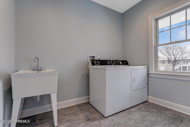 laundry room featuring washing machine and dryer and a healthy amount of sunlight