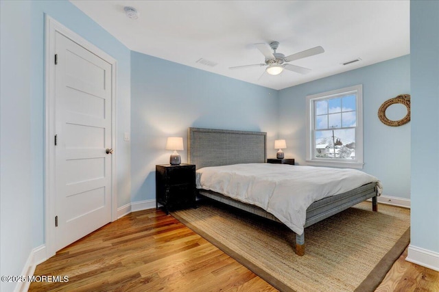 bedroom with ceiling fan and hardwood / wood-style flooring