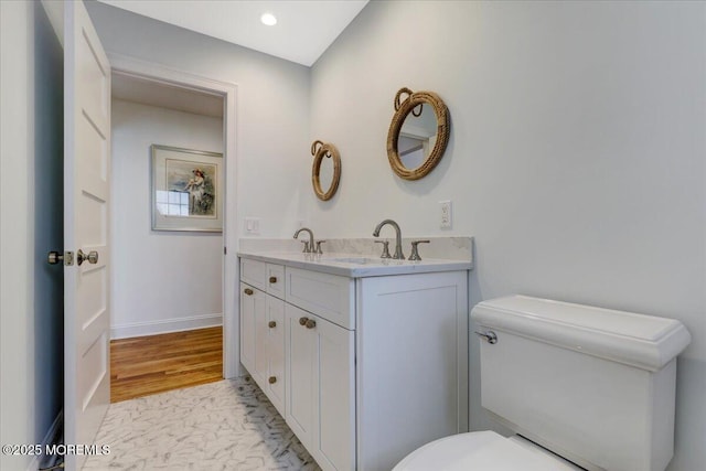 bathroom with toilet and vanity