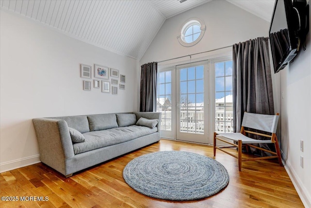 living room with wood-type flooring and vaulted ceiling