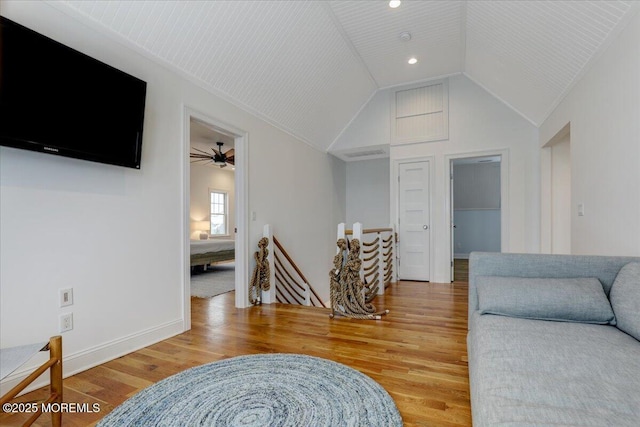 living room with vaulted ceiling, hardwood / wood-style floors, and ceiling fan