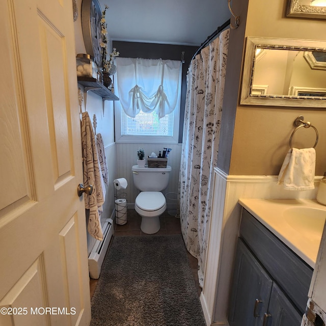 bathroom with a baseboard radiator, curtained shower, toilet, and vanity