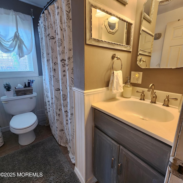 bathroom featuring toilet, vanity, and tile patterned flooring