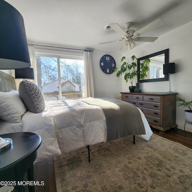 bedroom featuring ceiling fan and dark hardwood / wood-style floors