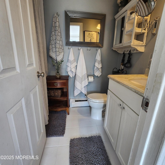 bathroom with toilet, baseboard heating, tile patterned floors, and vanity