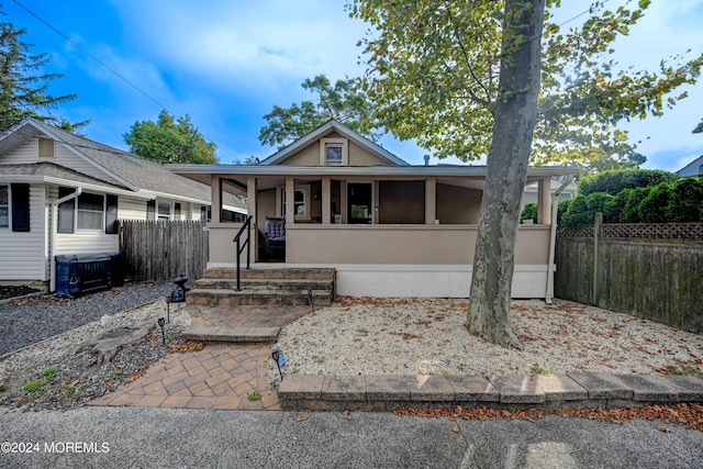 view of front of home with a sunroom