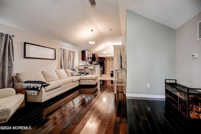 living room featuring lofted ceiling and dark hardwood / wood-style floors