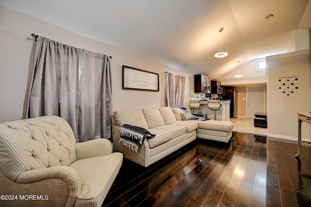 living room featuring vaulted ceiling and dark hardwood / wood-style floors