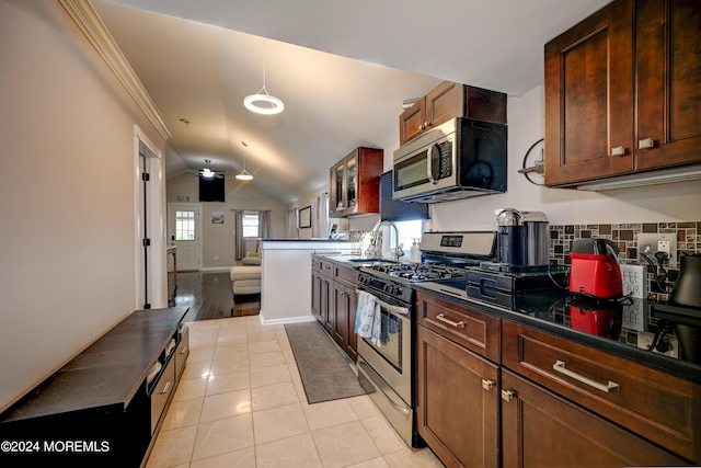 kitchen with appliances with stainless steel finishes, lofted ceiling, sink, ceiling fan, and light tile patterned floors