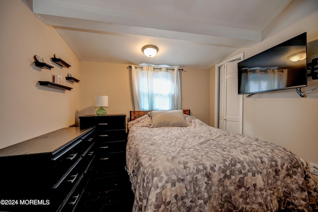 bedroom with lofted ceiling with beams