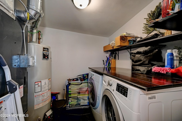 washroom featuring washing machine and dryer and water heater