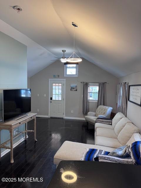 living room with vaulted ceiling, ceiling fan, plenty of natural light, and dark hardwood / wood-style floors