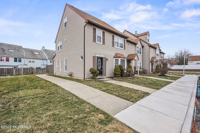 multi unit property featuring a front lawn