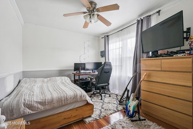 bedroom with ceiling fan, crown molding, and hardwood / wood-style flooring