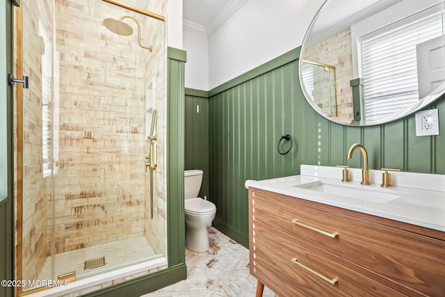 bathroom featuring toilet, ornamental molding, a shower with shower door, and vanity