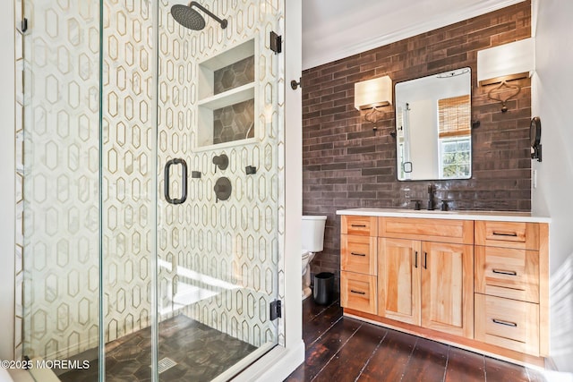 bathroom with toilet, a shower with door, wood-type flooring, and vanity