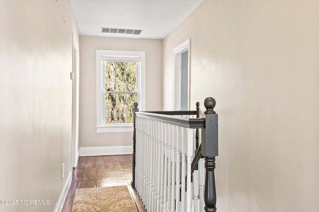 corridor with dark hardwood / wood-style flooring