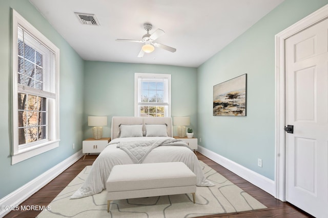 bedroom with ceiling fan and dark hardwood / wood-style floors