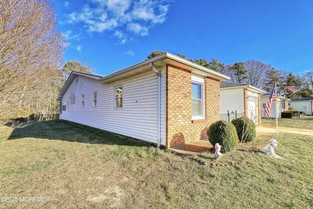 view of side of property with a yard